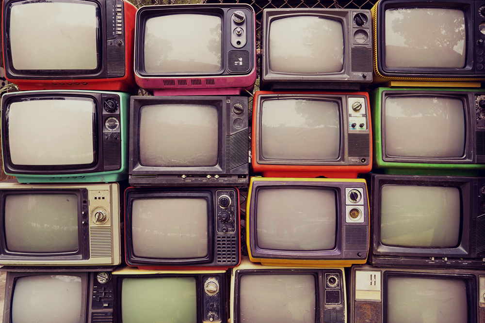 Pattern wall of pile colorful retro television (TV) – vintage filter effect style.